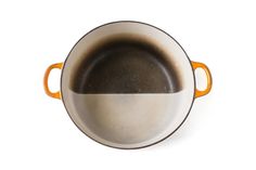 an orange and white pan on a white background