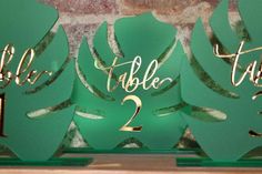 the table numbers are green and gold with leaves on each one, along with two smaller ones