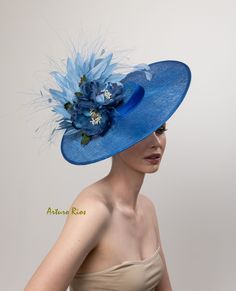 Love this hat shape, very chic! Cobalt blue derby hat made on a round straight sinamay shape, embellished with 2 silk organdy and velvet magnolias, silk satin band, blue goose and peacock feathers. Seated on a velvet headband. One size fit all. All my hats are hand made to order, please allow 1-2 weeks, if this is a rush order, please contact me before ordering. Hat comes with a pretty hat box for domestic orders only. International orders, hat will be packed nicely to protect it during the trip Blue Fitted Sinamay Fascinator, Sinamay Fascinator With Curved Brim For Royal Ascot, Blue Sinamay Fascinator For Party, Blue Fascinator For Royal Ascot Garden Party, Blue Sinamay Hat For Summer, Blue Fascinator For Garden Party At Royal Ascot, Blue Fascinator For Garden Party And Royal Ascot, Blue Sinamay Party Fascinator, Blue Brimmed Top Hat For Royal Ascot