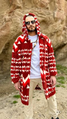 Indulge in unparalleled comfort and style with our men's hooded cardigan. Crafted from luxuriously soft double-sided faux fur, this piece offers a lavish embrace. Adorned with striking southwestern patterns, it evokes the spirit of the desert landscape. Whether you're lounging at home or venturing out, this cardigan promises warmth and sophistication wherever you go.  Every piece is made to the order and 100% handmade. Native American Pattern, Faux Fur Cardigan, Faux Fur Hooded Coat, Native American Patterns, Fur Cardigan, American Pattern, Southwestern Patterns, Hooded Faux, Desert Landscape