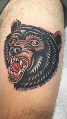 a man's thigh with a bear tattoo on it