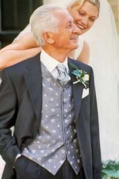 an older man in a tuxedo is holding his bride