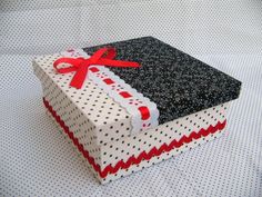 a black and white gift box with red ribbon