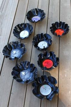 several black and red bowls sitting on top of a wooden floor