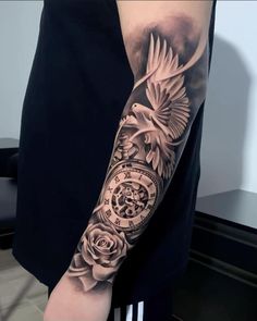 a man's arm with a clock and rose tattoo on it