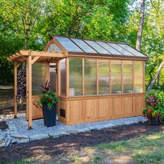 a small wooden structure with plants in it