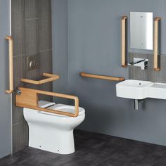 a bathroom with a toilet, sink and wooden support bars on the wall above it