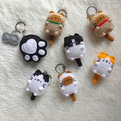 four keychains made to look like cats