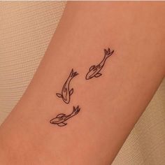 two koi fish tattoo on the right side of the arm, one black and one white