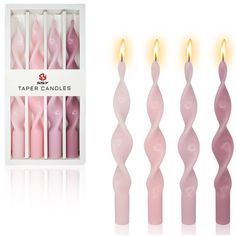 pink candles are in a box and one is lit