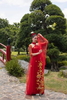 a woman in a red dress is posing for the camera