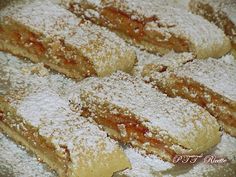 powdered sugar covered pastries sit on a plate