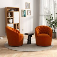 two orange chairs sitting next to each other in a living room