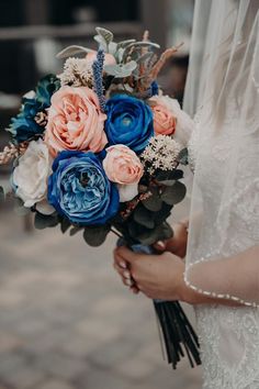 a woman holding a bouquet of flowers in her hands