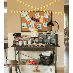 an old fashioned typewriter sitting on top of a table next to a wall with pictures