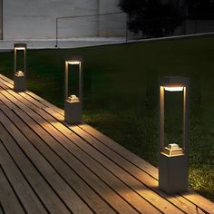 some lights that are on the side of a wooden floor in front of a building