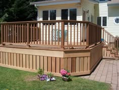 a large wooden deck in the middle of a yard