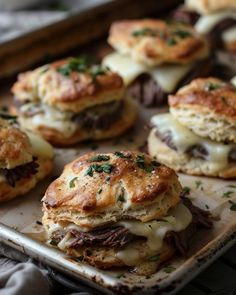 there are some biscuits with meat and cheese on them