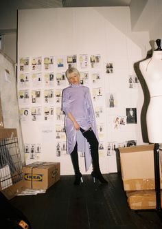 an older woman standing in front of a mannequin