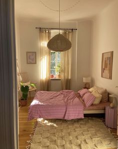 a bedroom with a bed, rug and window