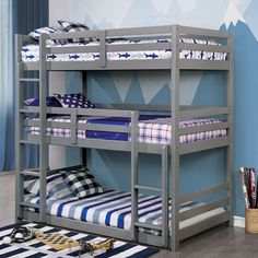 a bunk bed with blue and white striped bedspread in a child's room