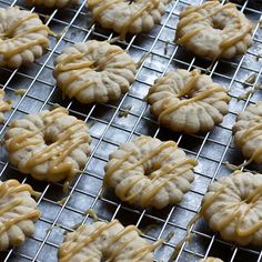 some cookies are cooling on a rack and ready to be baked in the oven for consumption