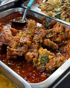 several trays of food with meat and vegetables in them