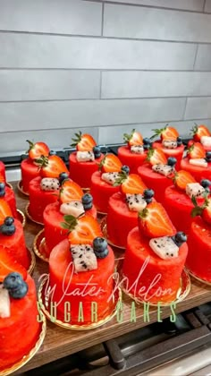 several cakes with fruit on them sitting on top of a counter