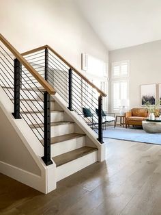 a living room filled with furniture and a stair case