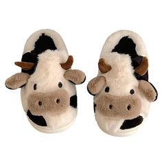 a pair of slippers with a cow on them