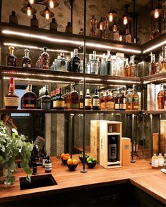 the shelves are filled with various bottles and glasses on top of wooden countertops