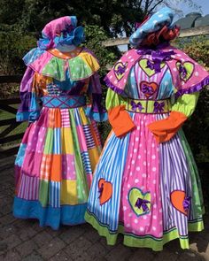 two women in colorful dresses standing next to each other