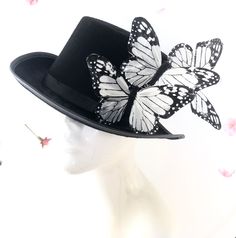 Top hat with monarch butterflies, butterfly hat, black steampunk hat with butterflies From our Whimsical Collection, this elegant women's hoop hat features monarch butterflies on a black fascinator base. Pictured are black and white monarch butterflies; you have the option to pick others butterfly colors as well I N C L U D E D Butterflies on clip attached to the hat and is removable. In secure box packaging to keep form. S H I P P I N G - Processed same day or within 24 hours. 1-2 day guarantee Red Mask Masquerade, White Top Hat, Butterfly Colors, Elegant Face Mask, Butterfly Hat, Victorian Top, Black Steampunk, Steampunk Top, Steampunk Top Hat