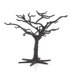 a metal sculpture of a tree with no leaves on the branches, against a white background