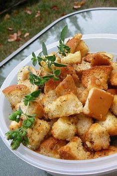 a white plate topped with croutons and herbs