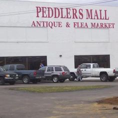 an antique and flea market with trucks parked in front