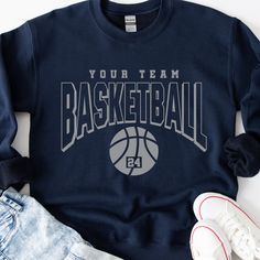 a sweatshirt with the words your team basketball on it and a pair of sneakers next to it