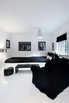 a black and white living room with couches