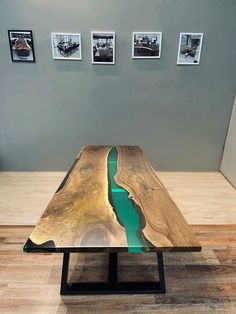 a wooden table sitting on top of a hard wood floor covered in green liquid water