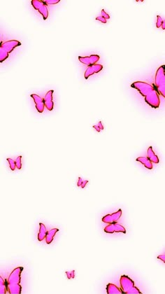 pink butterflies flying in the air on a white background