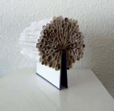 an origami sculpture on top of a white table