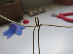 a pair of scissors and some twine on a table