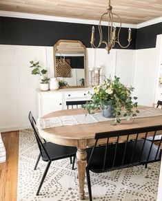 a dining room table with chairs and a chandelier hanging from it's ceiling