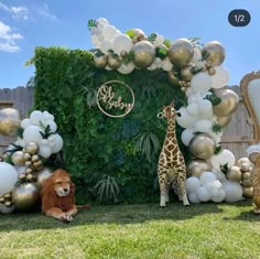 a giraffe and other animals are sitting in front of a backdrop with balloons