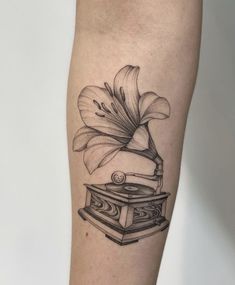 a black and white tattoo of a record player