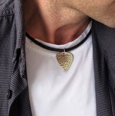 Looking for personalized gifts for guitar players? Have a look our personalized guitar pick hammered pendant . Engraved guitar pick necklace for true music fans.  The best gift idea for your friend musician! A refined choice, this cord necklace creates a streamlined look.  Crafted of high quality leather cord, the necklace is paired with a charm shaped as a guitar pick.  Polished to a bright shine, the pendant comes with a hammered or just polished finish. I can engrave it with your words to mak Gifts For Guitar Players, Mens Necklace Personalized, Guitar Pick Jewelry, Mens Leather Necklace, Guitar Picks Personalized, Custom Guitar Picks, Gift For Musician, Guitar Pick Necklace, Wallet Insert Card