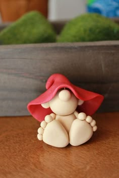 a small figurine sitting on top of a wooden table