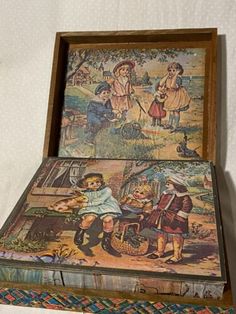 two children's books are stacked on top of each other in a wooden box