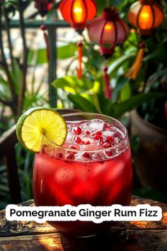 a drink with a lime slice on the rim and garnished with pomegranates