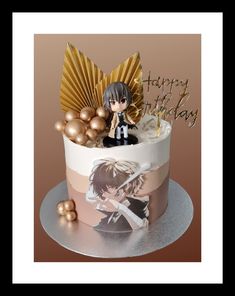 a birthday cake decorated with an anime figure and gold decorations on top, along with some balloons